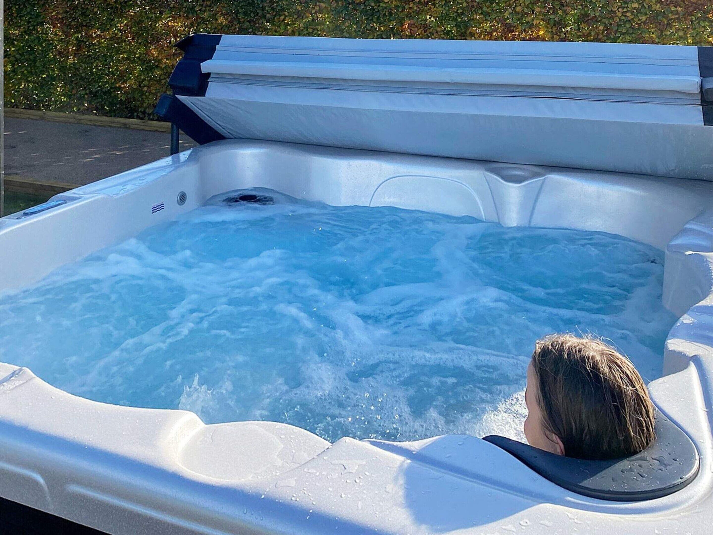 A hot tub with a person submerged in it.