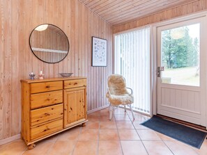 A wooden interior with a cabinet, a chair, a door, and a window. - 6 Person Holiday Home in Fjerritslev (Fjerritslev)