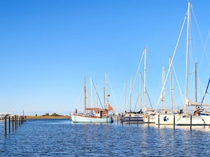 Ein Yachthafen mit mehreren Booten, die an hölzernen Stegen festgemacht sind.