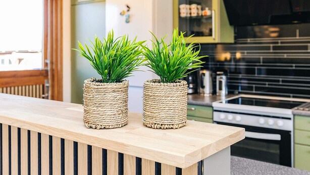 A kitchen with two woven planters on a wooden counter. - 6 Person Holiday Home in Laeso (Læsø)