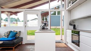 A modern kitchen with white cabinets, a built-in oven, and a coffee maker. - 6 Person Holiday Home in Aabenraa-by Traum (Aabenraa)