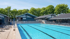 A swimming pool with clear blue water, surrounded by lounge chairs and covered seating areas. - 6 Person Holiday Home in Aabenraa-by Traum (Aabenraa)
