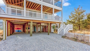 A multi-story building with a covered outdoor area, wooden beams, and a white fence. - Serene Bay View, Steps to Broadkill Beach
Relax and make memories for the books! (Milton)