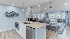 A modern kitchen with a central island, stainless steel appliances, and pendant lighting. - Serene Bay View, Steps to Broadkill Beach
Relax and make memories for the books! (Milton)