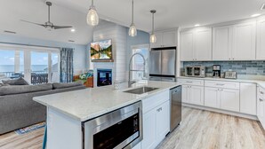 A modern kitchen with white cabinets, stainless steel appliances, and pendant lighting. - Serene Bay View, Steps to Broadkill Beach
Relax and make memories for the books! (Milton)