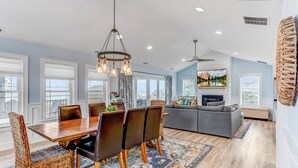 A spacious living area with a dining table, chairs, and a sofa. - Serene Bay View, Steps to Broadkill Beach
Relax and make memories for the books! (Milton)
