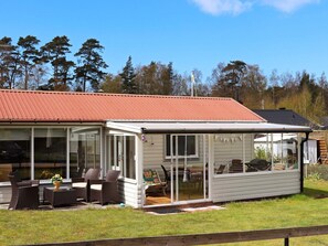 A single-story house with a covered patio area, large windows, and a red roof. - 5 Person Holiday Home in Mellbystrand (Mellbystrand)