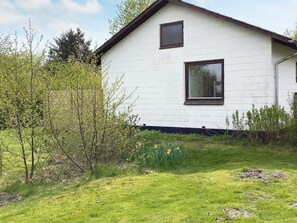 A white building with a gabled roof, a small window, and a door. - 6 Person Holiday Home in Norre Nebel (Norre Nebel)