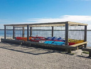 A concrete structure with a metal fence, possibly a boat storage area, by a body of water. - 10 Person Holiday Home in Vinderup-by Traum (Vinderup)