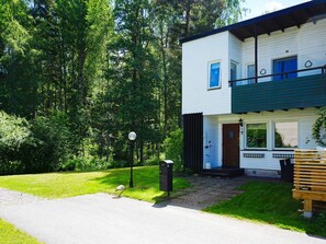 A two-story house with a front porch, a mailbox, and a bench. - 4 Star Holiday Home in Ekero (Ekerö)
