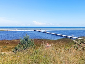 A pier extending into a body of water with people on it. - 6 Person Holiday Home in Hadsund (Hadsund)
