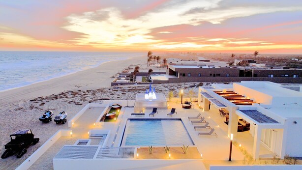 A resort with a pool, sun loungers, and a view of the beach at sunset. - Mexico,Oceanfront vacation villa,Lighthouse Point, near Costa Palmas, private (La Ribera)