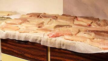 A display of raw fish on a wooden counter.
