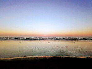 A beach with a calm sea and a clear sky. - 6 Person Holiday Home in Lokken (Lokken)