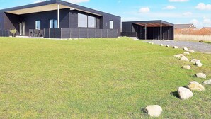 A modern two-story building with a flat roof and large windows.