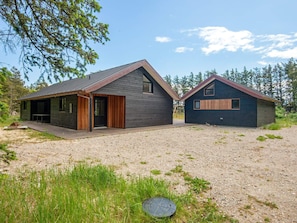 A modern two-story house with a covered patio and a separate cabin. - 4 Star Holiday Home in Lokken (Lokken)