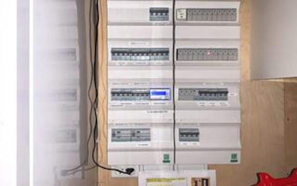 A utility panel with multiple circuit breakers and wiring.