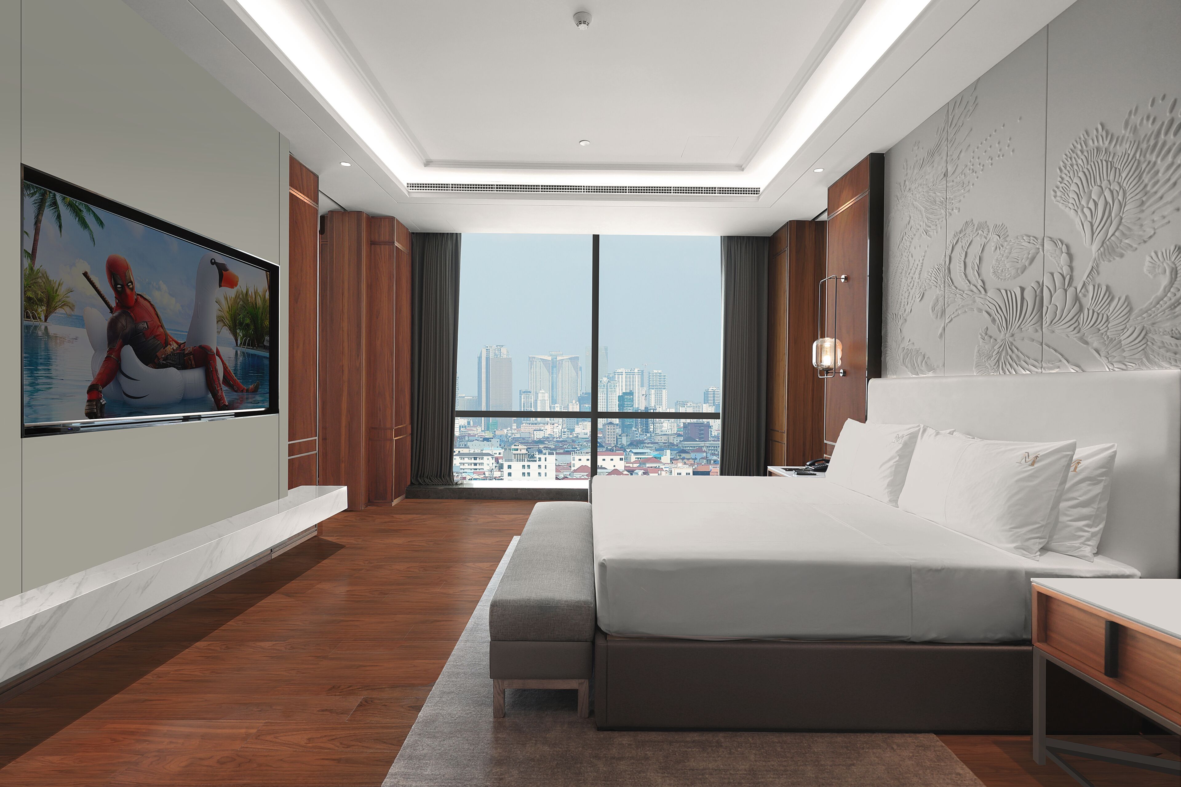 A modern hotel room with a large bed, a city view, a painting on the wall, and a wooden floor.