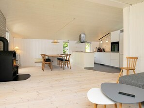 Un intérieur moderne comprenant un coin repas, une cuisine et un espace salon.