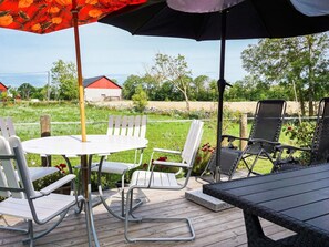 Relax on the patio with a round table and comfortable seating for a peaceful retreat.