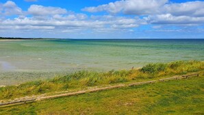 A coastal landscape with a clear sky and calm sea.