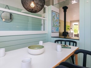 A dining area with a white table, a green bowl, and a map on the wall. - 5 Person Holiday Home in Aabenraa (Aabenraa)