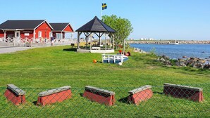 A coastal area with a red building labeled 'INSEGLET,' a gazebo, and a fenced playground. - 5 Person Holiday Home in Solvesborg (Sölvesborg)
