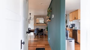 A modern kitchen with wooden cabinets, a built-in oven, and a countertop.