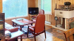 A cozy living room with a fireplace, a television, and a comfortable seating area. - 4 Person Holiday Home in Reksteren (Tysnes)