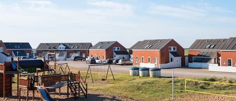 A residential area with multiple houses, a playground, and a parking lot.