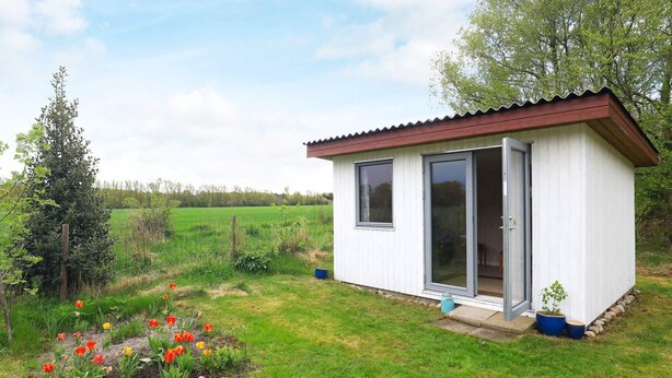 A small, single-story building with a red roof and a sliding glass door. - 8 Person Holiday Home in Laeso (Læsø)
