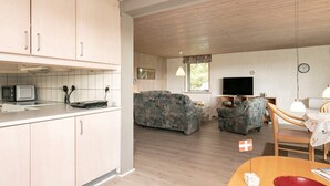 A compact living space with a kitchenette, a sofa, a television, and a dining table. - 8 Person Holiday Home in Laeso (Læsø)