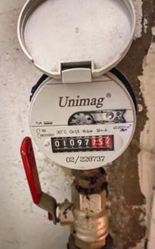 A Unimag water meter attached to a pipe.