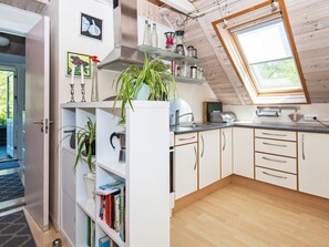 A kitchen with white cabinets, a countertop, a window, and a skylight. - 5 Person Holiday Home in Odder (Odder)