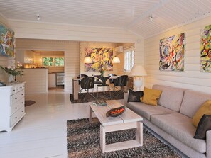 A modern interior with a dining area, kitchen, and living space.