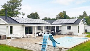 A house with a swimming pool, a slide, and solar panels on the roof. - 4 Star Holiday Home in Rodvig Stevns (Rodvig Stevns)