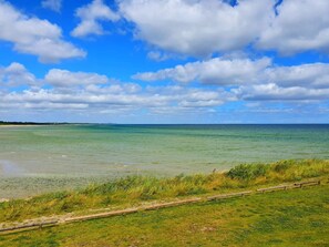 A coastal landscape with a clear sky and calm sea.