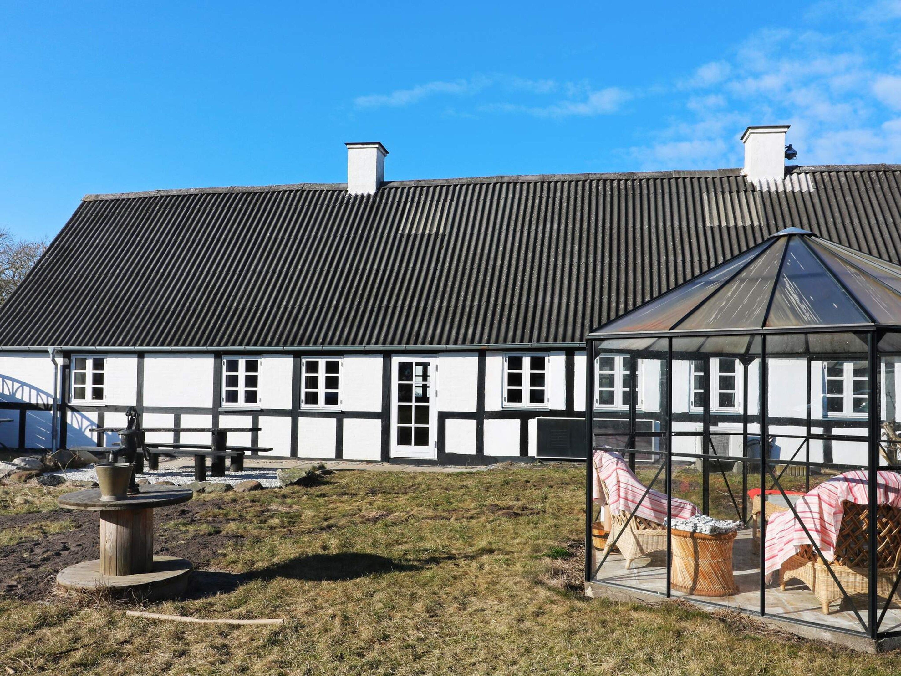 A traditional building with a gabled roof and a glass conservatory.