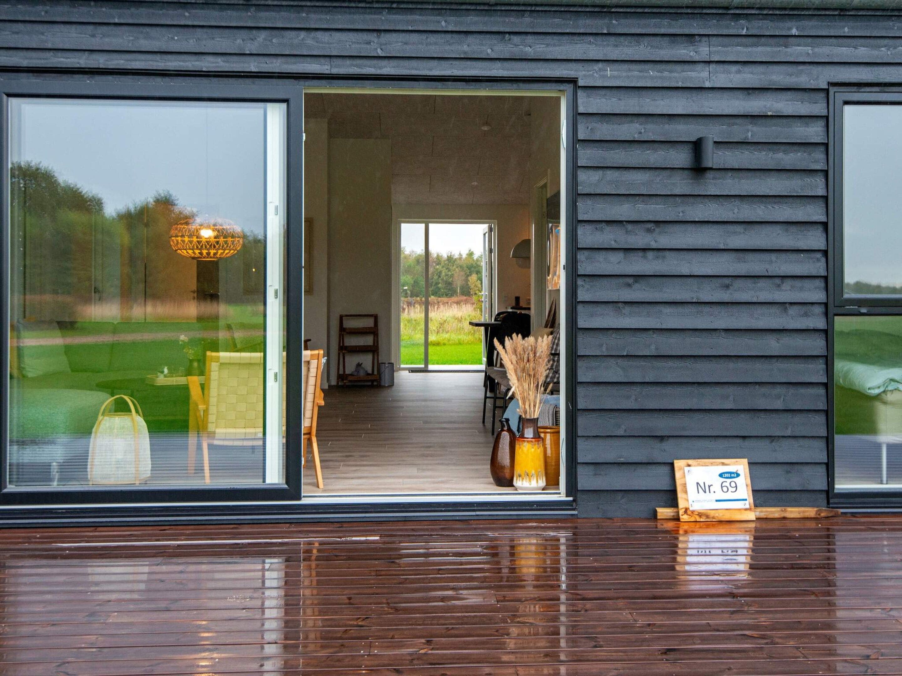 A modern building with a large glass door leading to an interior space.