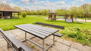 A park with a picnic table, a gazebo, and playground equipment. - 4 Star Holiday Home in Vestervig (Vestervig)
