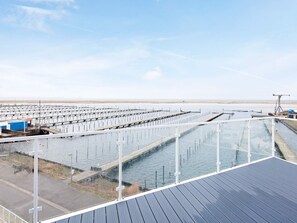 A large aquaculture facility with multiple tanks and a viewing platform.