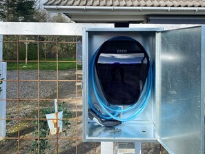 A metal electrical box with a BMW logo, a blue cable, and a rusty plant pot. - 4 Star Holiday Home in Juelsminde (Horsens)
