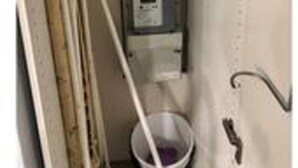A narrow hallway with a utility panel, a mop, and a bucket. - 5 Star Holiday Home in Esbjerg V (Esbjerg)