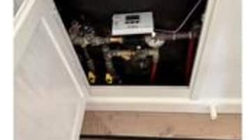 An open cabinet with a control panel inside.