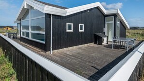 A modern black building with large windows and a deck. - 8 Person Holiday Home in Hjorring (Hjørring)