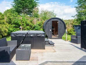 A hot tub, outdoor seating, and a circular wooden structure with an open door. - 4 Star Holiday Home in Ebeltoft (Ebeltoft)