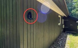 A wooden building with a circular window and a door. - 6 Person Holiday Home in Frederiksvaerk (Frederiksvaerk)