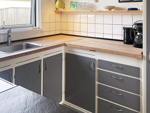 A kitchen with a sink, cabinets, and a countertop. - 4 Star Holiday Home in Thyboron (Thyborøn)