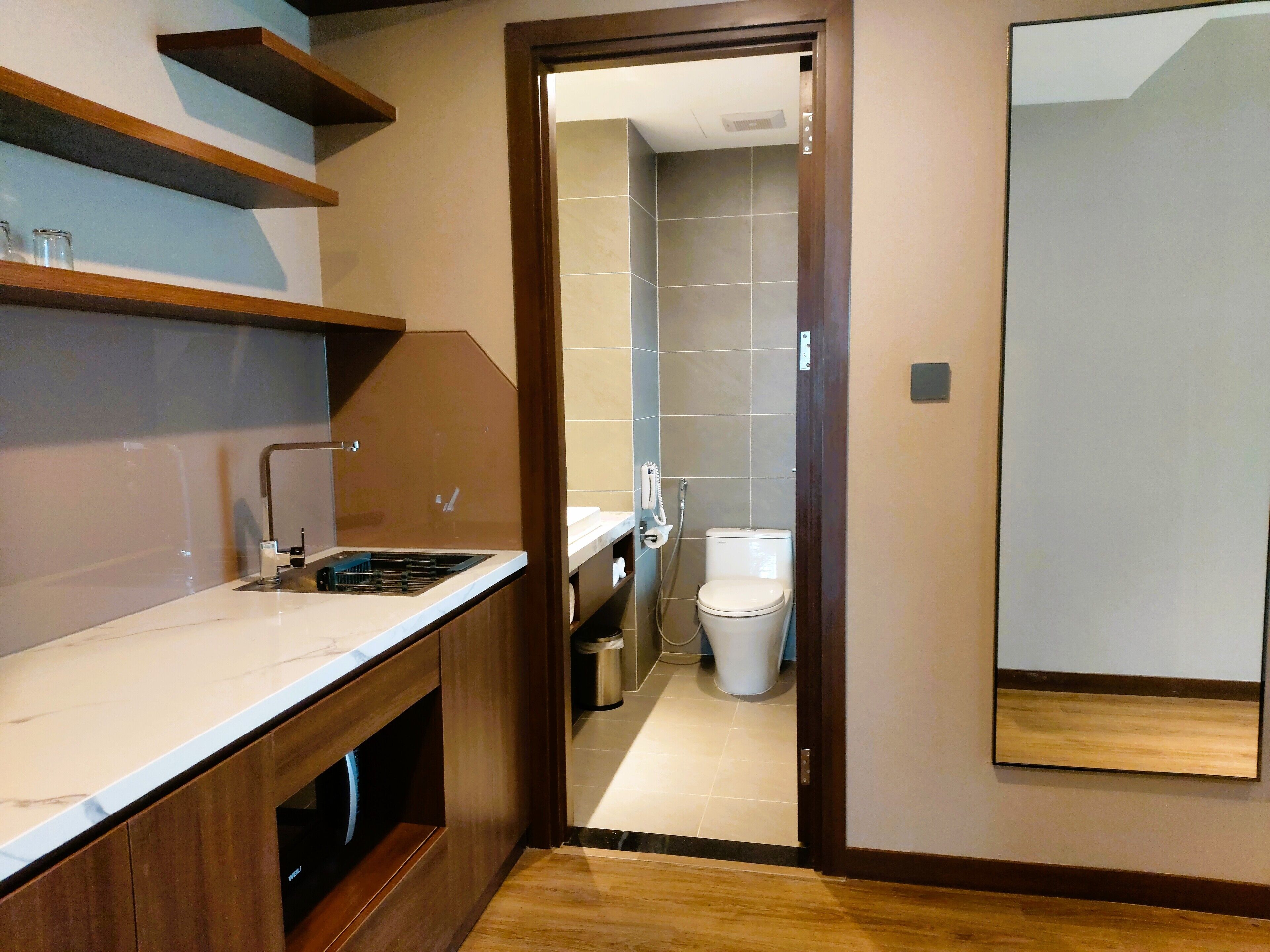 A modern kitchen with a built-in stove and a wooden countertop.