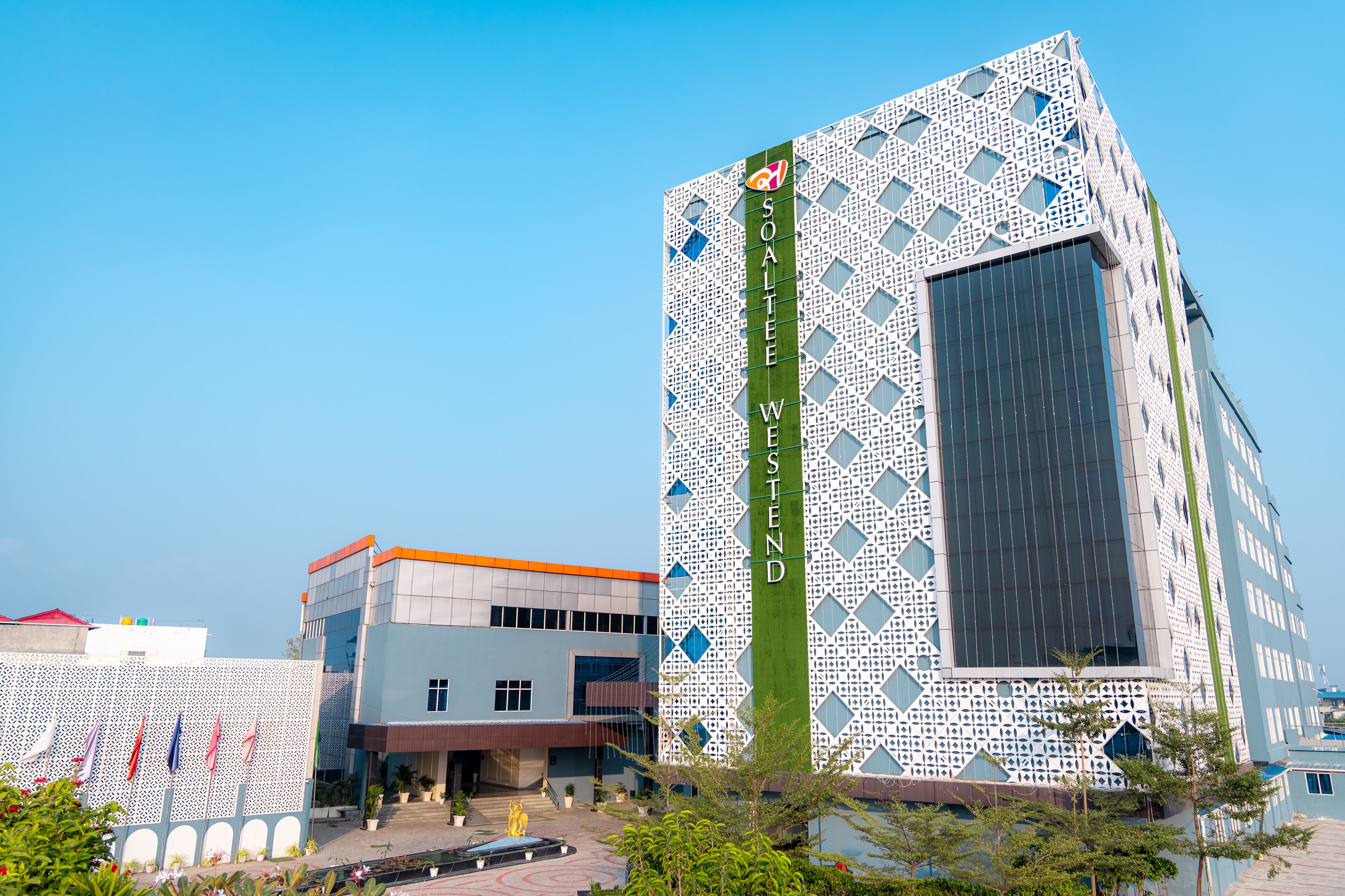 A modern building with a patterned facade and a prominent vertical sign reading "SOALTEE WESTEND".